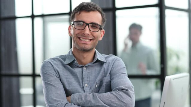 Businessman smiling outside a boardroom before meeting with colleagues