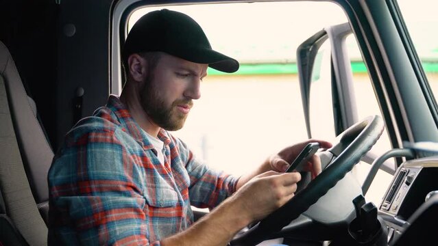 Professional trucker using truck gps navigation to transport and deliver goods to the destination. Transportation services.