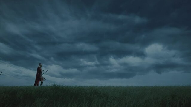Five Roman soldiers go out to attack at evening in a green field. Slow motion