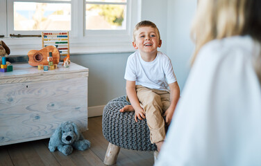 Therapist, psychology and boy on a chair, talking and child development with a smile, foster home and adoption. Male kid, young person or counsellor in an office, speaking and consultation for growth - obrazy, fototapety, plakaty