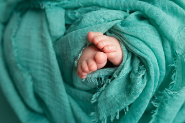 twisted child. Soft feet of a newborn.