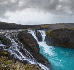 Picturesque waterfall Sigoldufoss autumn view. Season changing in southern Highlands of Iceland.