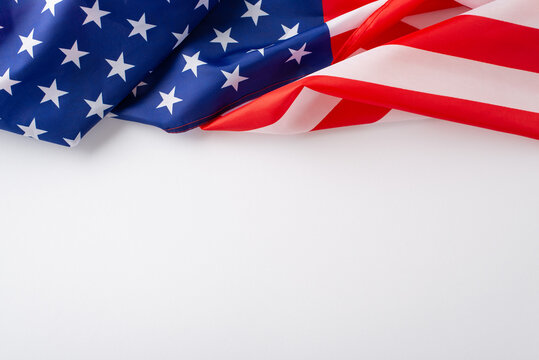 Celebrating the essence of the public holiday: Embrace the occasion with this top-view photo, highlighting the American flag on white isolated background. Perfect for ads or text overlays