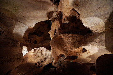 BURNET, TEXASUSA - JULY 3rd 2023: a family with a teenage girl on a road trip during school summer holidays, visiting Longhorn Cavern State Park with its intricate paths and natural stone works.