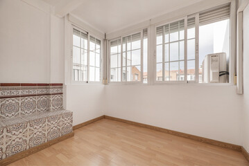 Enclosed terrace with French-style white aluminum glazing