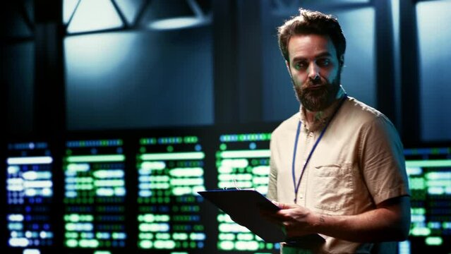 Admin walking in data center supporting AI through high performance computing, hosting specialized storage and networking hardware. Engineer ensuring server room internal hardware functions properly