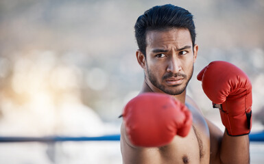 Fitness, boxing or male boxer in a ring training, exercise and punching with strong power in...