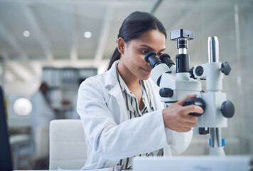 Science, microscope and innovation with a woman in a laboratory for medical research or experiment....