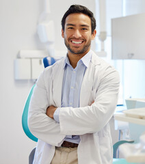 Dentist, portrait and man with arms crossed for healthcare service, dental hospital or insurance in consultation office. Happy asian person or doctor with teeth, oral or hygiene health in clinic
