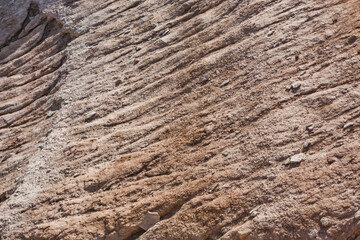 The slope of Mount Bokty from limestone and chalk deposits in the Kazakh steppe, the relief of the hillside, ditches and gullies washed out by water