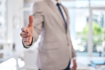 Closeup of a businessman stretching for a handshake in the office for partnership, greeting or...