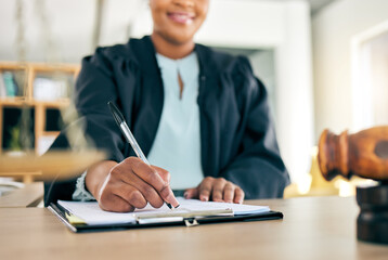 Legal, scale and hands of black woman lawyer writing for an investigation document or criminal case...