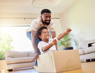 Father, son and playing at home with pretend car in a box on moving day in new property. Black family, house and real estate move of a dad and child together with play driving and fun in living room - obrazy, fototapety, plakaty