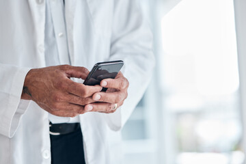 Phone, hands and doctor typing in hospital for research, telehealth and healthcare. Smartphone, medical professional and surgeon, expert or person on mobile app, wellness email or online consultation