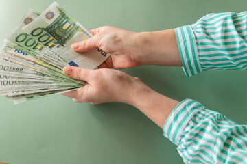  euro money on a green background.European Union money.One hundred euro banknotes hand counted on a...