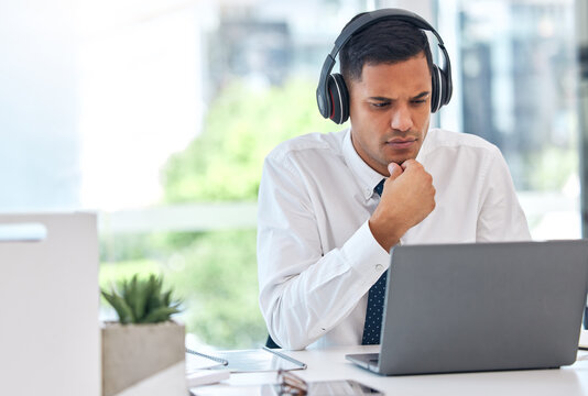 Businessman, laptop and thinking for decision, choice or listening to music at office desk. Man, accountant or financial advisor in wonder working on computer for business plan, proposal or ideas