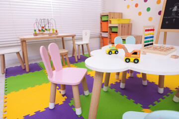 Stylish kindergarten interior with toys and modern furniture