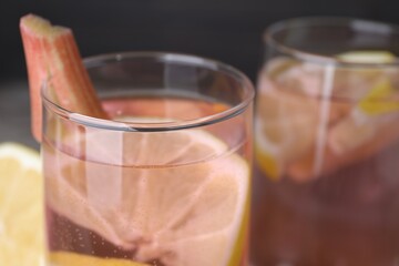 Glass of tasty rhubarb cocktail with lemon, closeup