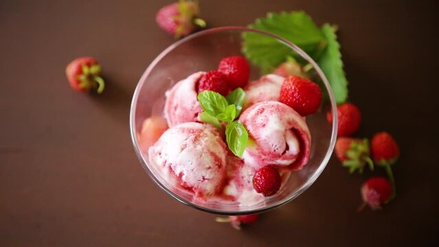 Balls of homemade strawberry ice cream in a bowl