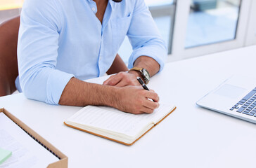 Business man, hands and writing in notebook at desk for planning summary, company report and review...