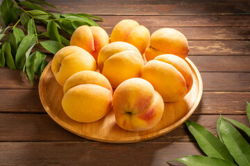 Yellow Peach with sliced on wooden Background, Fresh peach in wooden basket on wooden Background.