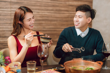 Happy couple dining in hotpots restaurant