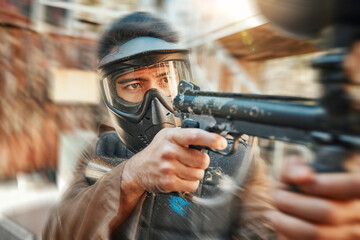 Paintball, blur and man in action with gun for tournament, competition and battle in nature....