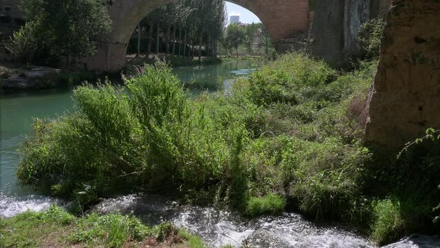 View of a river as the Trillo nuclear power plant is seen in the background in the Guadalajara province in Spain. Trillo nuclear power plant has a pressurized water reactor (PWR).