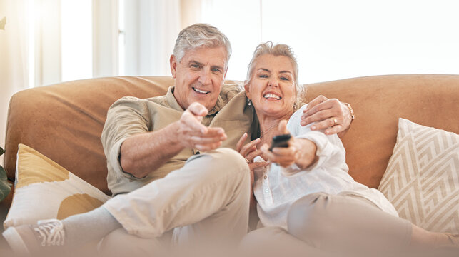 Happy senior couple, watching tv and sofa in relax for streaming, movie or series in living room at home. Portrait of elderly man and woman smile with remote for changing channel and entertainment