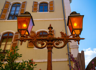 Fototapeta na wymiar Orange old lampposts in Annecy