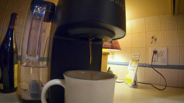 gopro tight but wide  shot of coffee pouring from keurig into mug