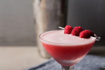 Alcoholic Clover Club cocktail pink gin, dry vermouth, raspberry sugar syrup, fresh lemon juice, fresh lime juice and egg white