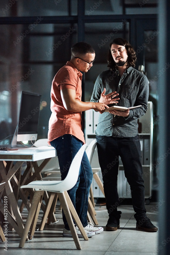 Poster hes giving me some really cool ideas. shot of two businessmen discussing in a notebook while working