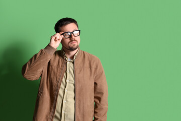 Fototapeta premium Handsome man in stylish eyeglasses on green background