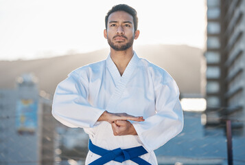 Karate, exercise and focus with a sports man in the city for self defense training or a combat workout. Fitness, health and fighting with a serious young male athlete or warrior in an urban town © Wesley JvR/peopleimages.com