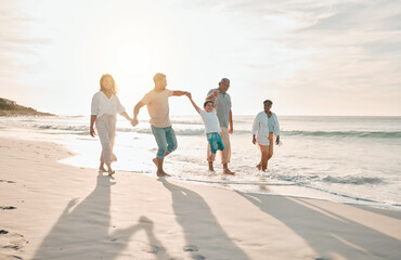 Holding hands, swing and big family at the beach walking with freedom, travel and bonding at...