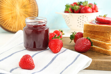 Tasty toasts with sweet strawberry jam and fresh berries on table