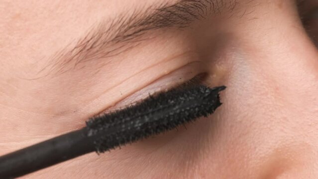 Pretty Woman Applying Black Mascara on Her Eyelashes. Preparing for Romantic Night in Beauty Saloon. Close Up Shot of Brown Eye. Makeup Tutorial for Social Media Platforms. Slow Motion 4K Prores 422 