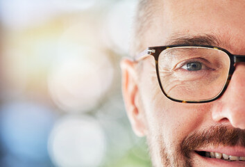 Half face, portrait and man with glasses for vision, eye care or optical wellness with mockup space. Prescription spectacles, smile and mature male model from Canada with a mock up bokeh background.