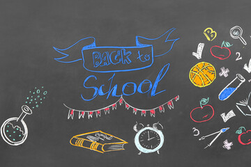Text BACK TO SCHOOL and different drawings on black chalkboard
