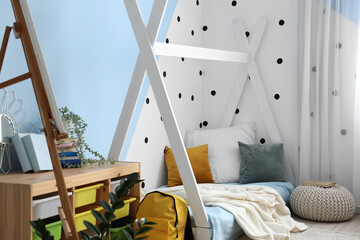 Fototapeta na wymiar Interior of children's bedroom with cozy bed, easel and pouf