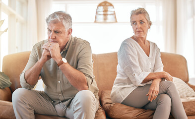 Senior couple, divorce and disagreement in conflict, fight or argument on living room sofa at home....