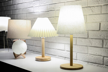 Different glowing lamps on table in dark room