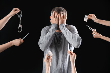 Mature junkie and hands with drugs on black background