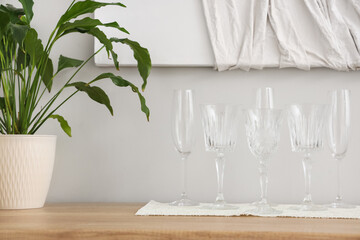 Set of different champagne glasses on wooden countertop, closeup