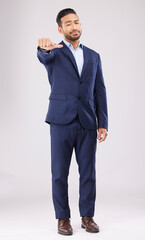 Thumbs down, disappointed and portrait of business man in studio with upset, unhappy and negative gesture. Emoji, professional and male person with hand gesture for bad review on white background