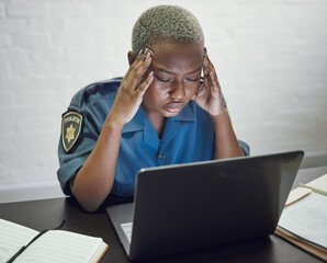 Police, woman with headache and working with stress on computer or frustrated with case, report or...