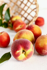 Many sweet peaches on white table