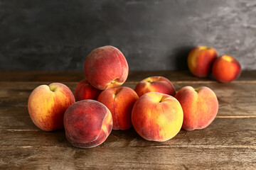 Fototapeta na wymiar Many sweet peaches on wooden table