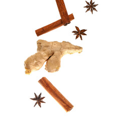 Flying cinnamon sticks, anise stars and ginger root on white background